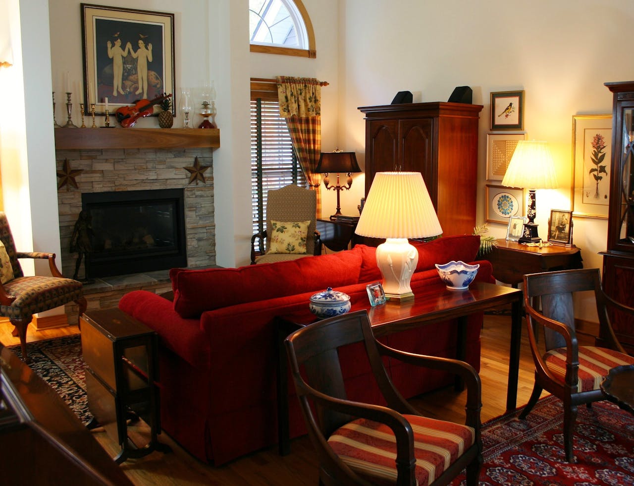 service-02 Warm and inviting living room featuring classic furniture and a fireplace, perfect for cozy evenings.