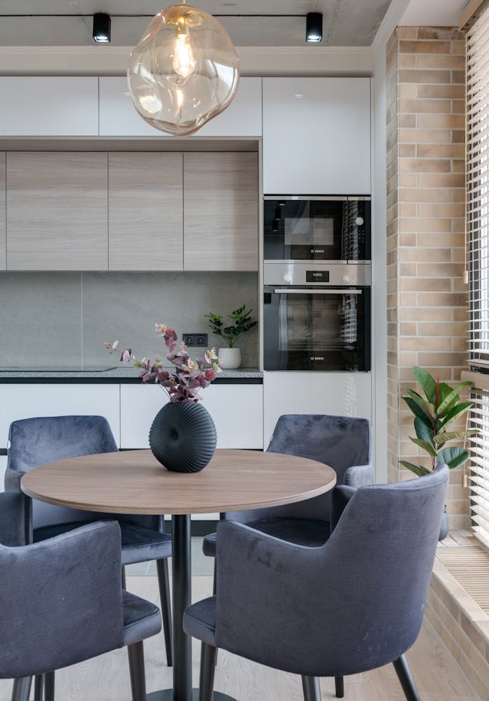 service-04 Contemporary dining space featuring a round table, upholstered chairs, and stylish decor.