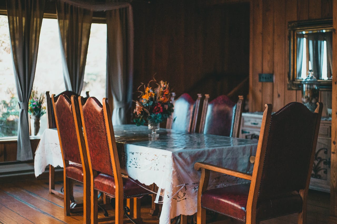service-06 Vintage dining room with elegant wooden chairs, table, and floral centerpiece enhancing home interior charm.